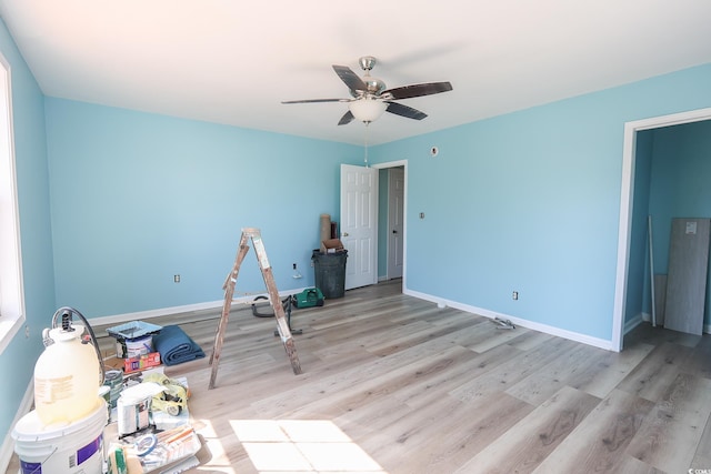 unfurnished bedroom with a ceiling fan, light wood-type flooring, and baseboards