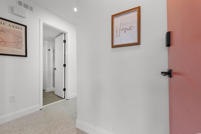 hallway with visible vents and baseboards