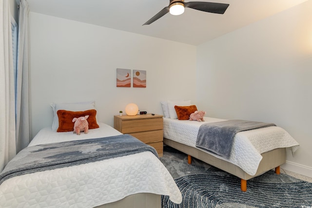 bedroom with baseboards and a ceiling fan