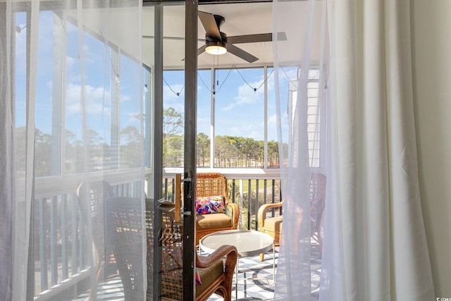 sunroom featuring a ceiling fan