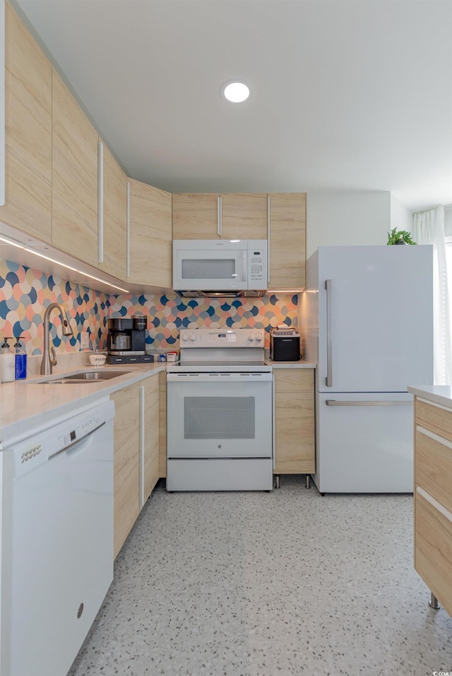 kitchen featuring white appliances and light brown cabinets