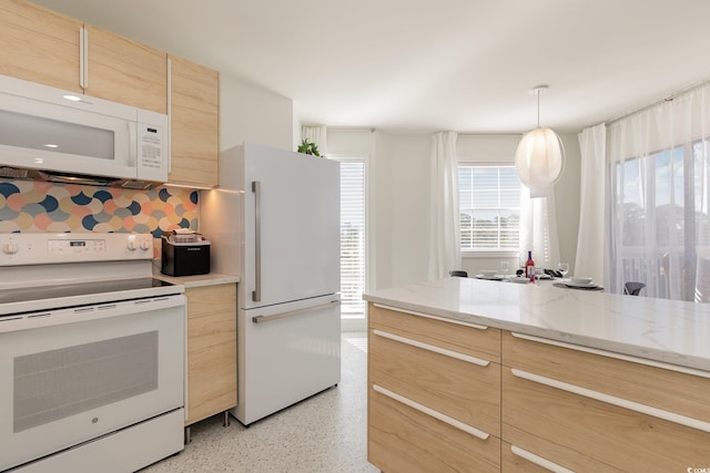 kitchen featuring light speckled floor, pendant lighting, decorative backsplash, light brown cabinetry, and white appliances