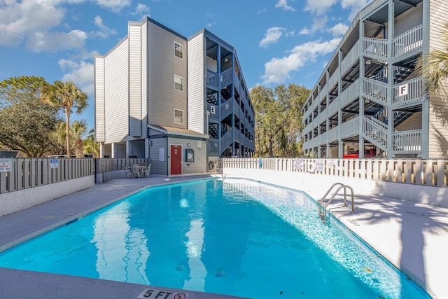 pool with fence and a patio