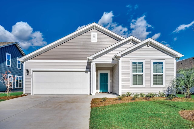 view of front of house featuring a garage, a front yard, and driveway
