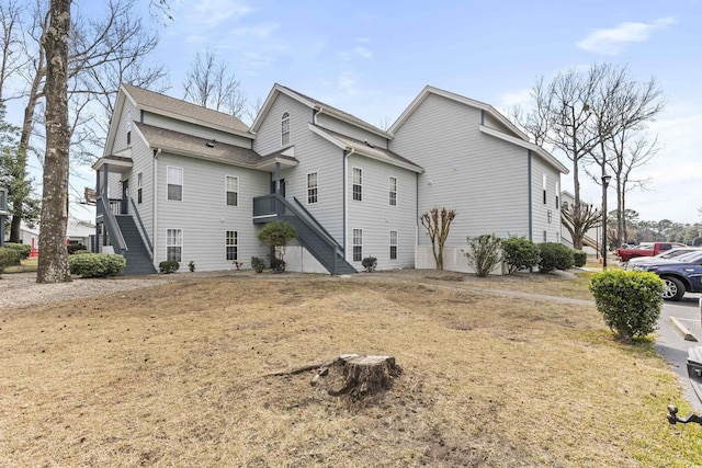 rear view of property featuring stairs