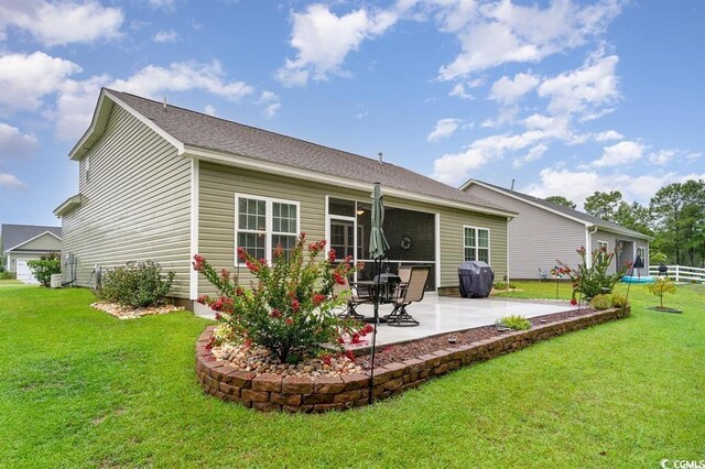 back of property featuring a patio area, fence, and a lawn