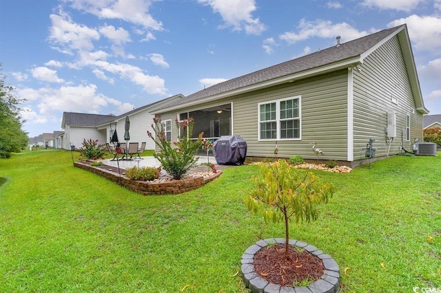 back of house featuring a yard, cooling unit, and a patio