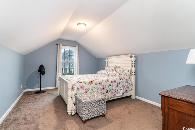 bedroom featuring light colored carpet, vaulted ceiling, and baseboards