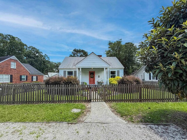 632 Magnolia Dr, Georgetown, SC 29440 - bungalow-style house featuring a fenced front yard, covered porch, a metal roof, and a gate