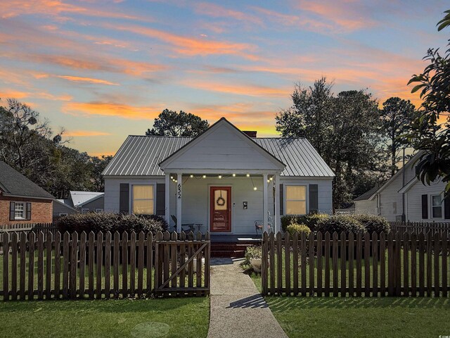 632 Magnolia Dr, Georgetown, SC 29440 - bungalow-style home featuring covered porch, a fenced front yard, a metal roof, and a gate