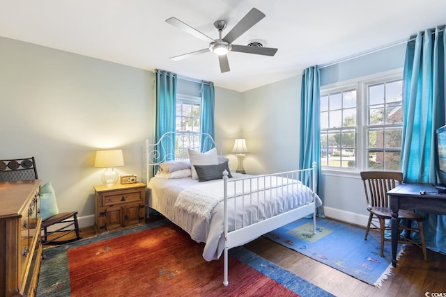 bedroom with wood finished floors, baseboards, and ceiling fan