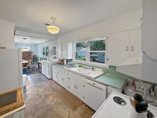 632 Magnolia Dr, Georgetown, SC 29440 - kitchen featuring white appliances, washer / dryer, white cabinetry, decorative light fixtures, and a chandelier