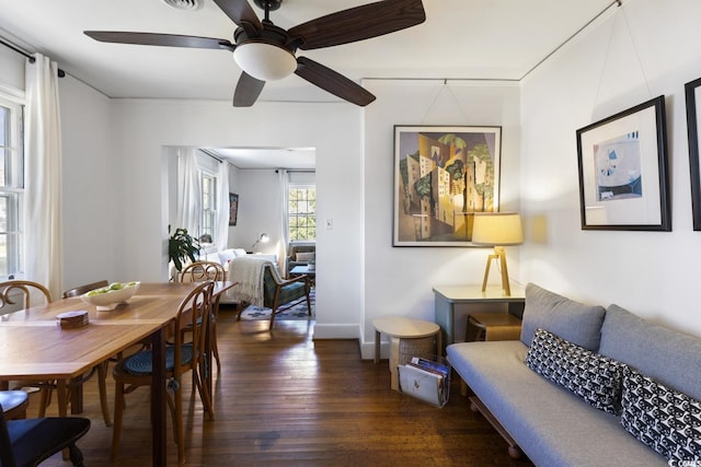 dining space with dark wood-style floors and a ceiling fan