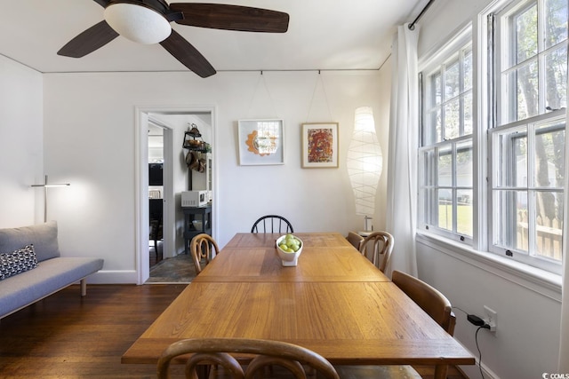 dining space featuring baseboards, plenty of natural light, dark wood-type flooring, and ceiling fan