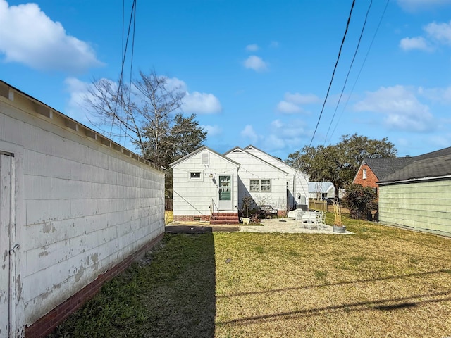 rear view of property with a patio area, a lawn, entry steps, and fence