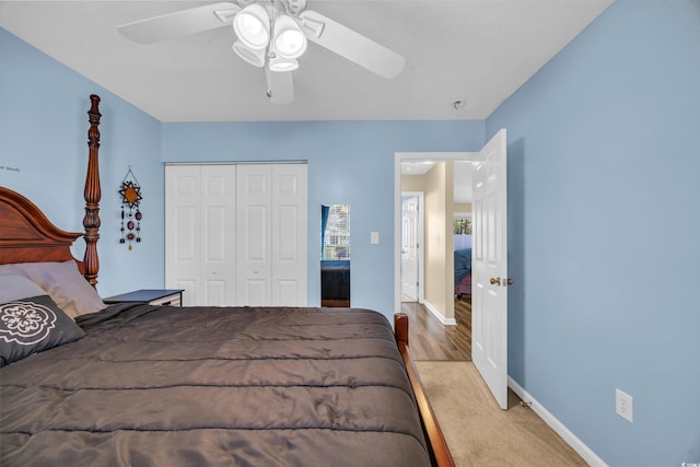 bedroom with a ceiling fan, baseboards, and a closet