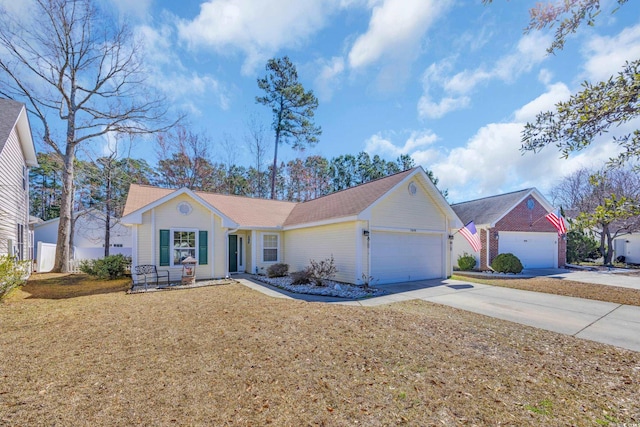 ranch-style house featuring a garage, a front lawn, and driveway