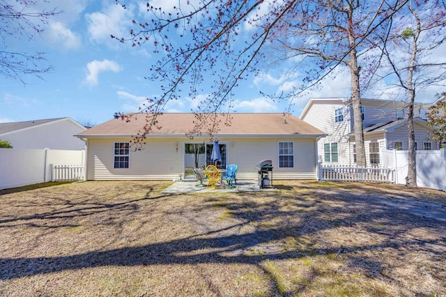 rear view of house with a patio and fence