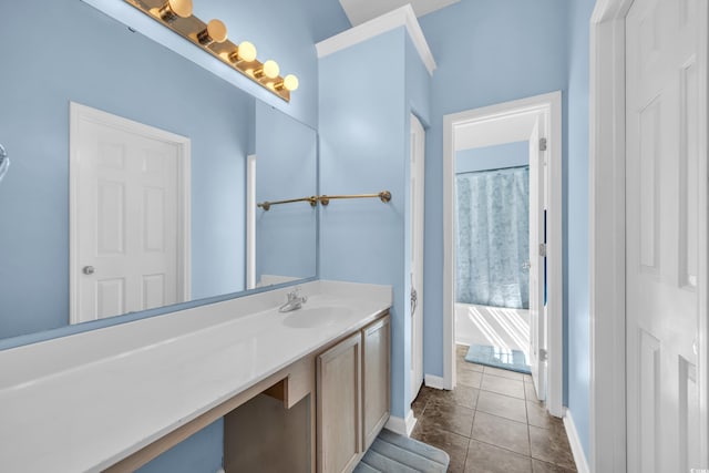 bathroom featuring baseboards, vanity, and tile patterned flooring