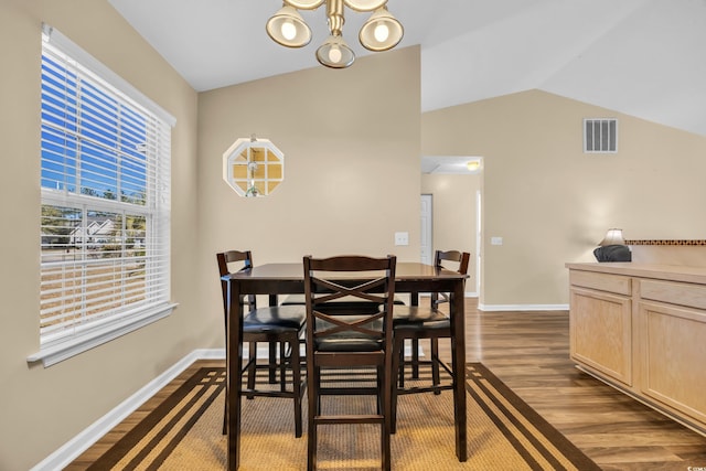 dining area with baseboards, visible vents, an inviting chandelier, vaulted ceiling, and dark wood-type flooring