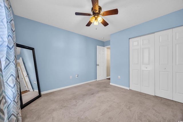 unfurnished bedroom with a closet, a ceiling fan, baseboards, and carpet floors