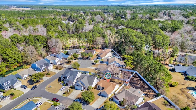 aerial view featuring a residential view and a wooded view