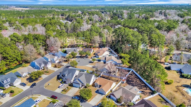 aerial view featuring a forest view and a residential view