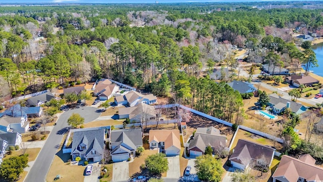 aerial view featuring a wooded view and a residential view