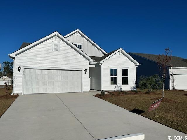 view of front of home featuring a garage, board and batten siding, and concrete driveway