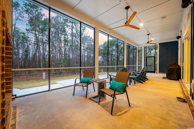 sunroom featuring ceiling fan