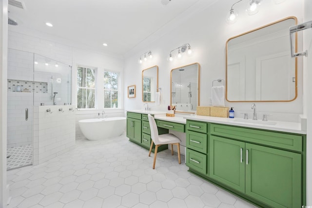 bathroom with a freestanding bath, ornamental molding, a stall shower, vanity, and tile patterned flooring