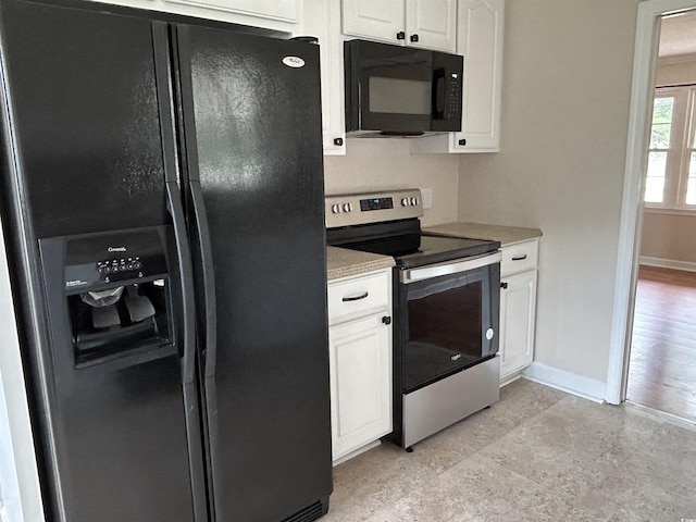 kitchen with light countertops, baseboards, white cabinets, and black appliances