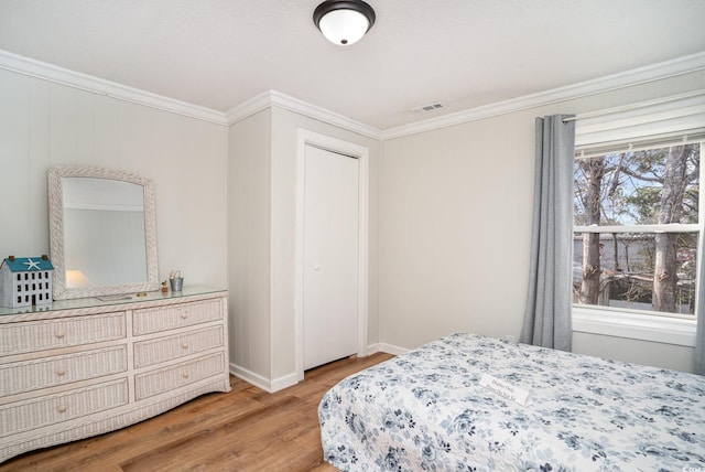 613 Calhoun Dr, Murrells Inlet, SC 29576 - bedroom with light wood-style floors, ornamental molding, and baseboards