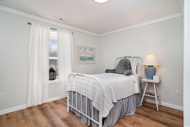 613 Calhoun Dr, Murrells Inlet, SC 29576 - bedroom with wood finished floors, crown molding, and baseboards