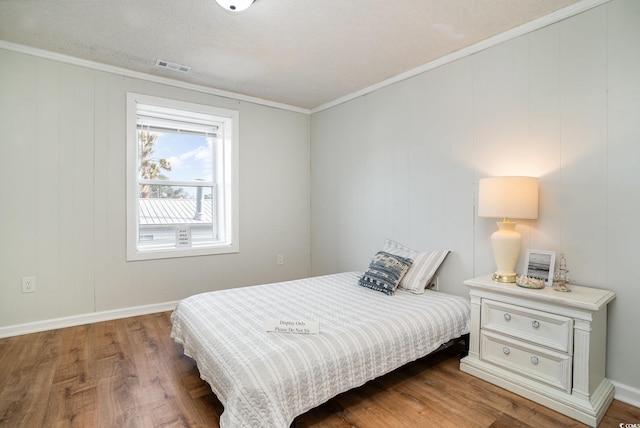 613 Calhoun Dr, Murrells Inlet, SC 29576 - bedroom featuring wood finished floors, baseboards, and crown molding