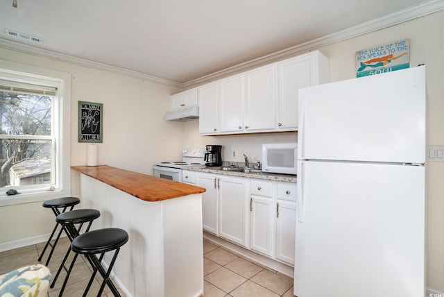 613 Calhoun Dr, Murrells Inlet, SC 29576 - kitchen featuring white appliances, under cabinet range hood, ornamental molding, light tile patterned flooring, and a kitchen breakfast bar