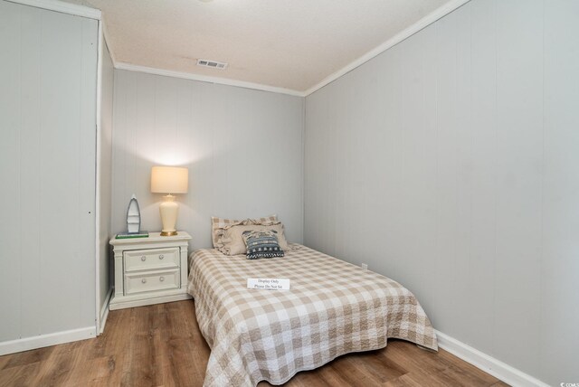 613 Calhoun Dr, Murrells Inlet, SC 29576 - bedroom with wood finished floors, crown molding, and baseboards