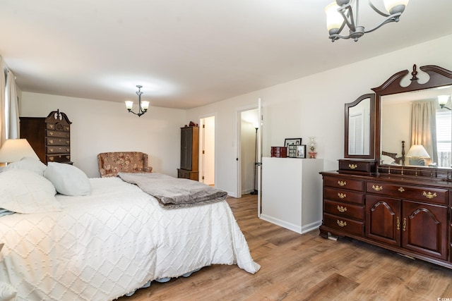 613 Calhoun Dr, Murrells Inlet, SC 29576 - bedroom featuring a chandelier, light wood-style flooring, and baseboards