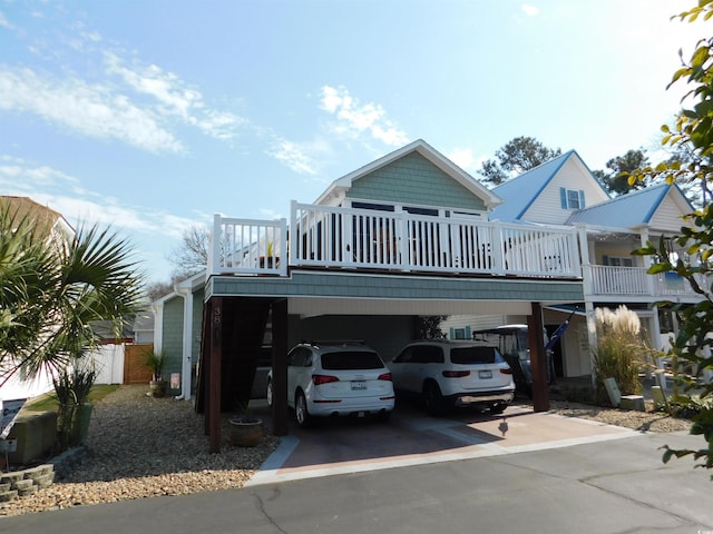 view of front of property featuring a carport and concrete driveway