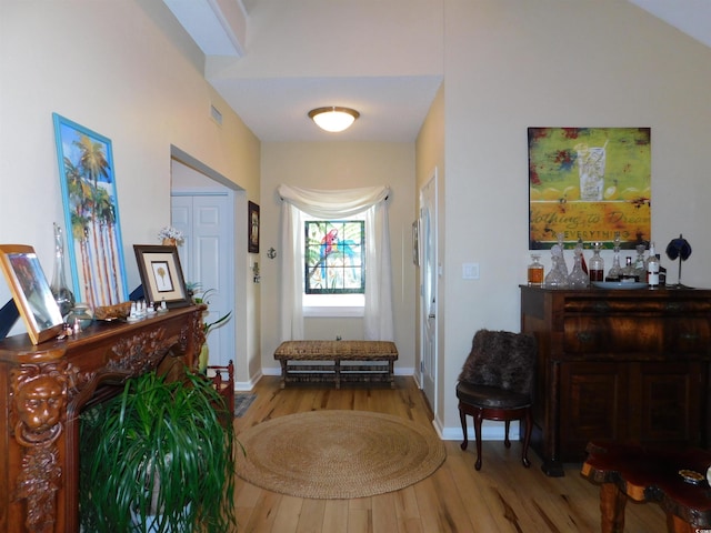 sitting room featuring wood finished floors, visible vents, and baseboards