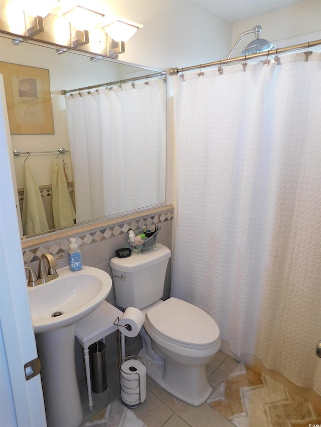 full bathroom with a shower with shower curtain, tile patterned flooring, and toilet