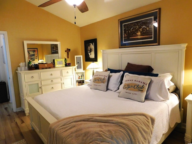 bedroom with lofted ceiling, ceiling fan, and wood finished floors