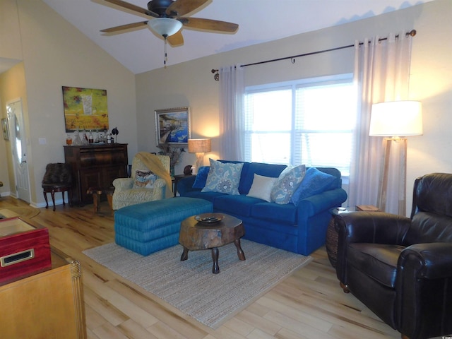 living area featuring high vaulted ceiling, ceiling fan, and light wood-style flooring