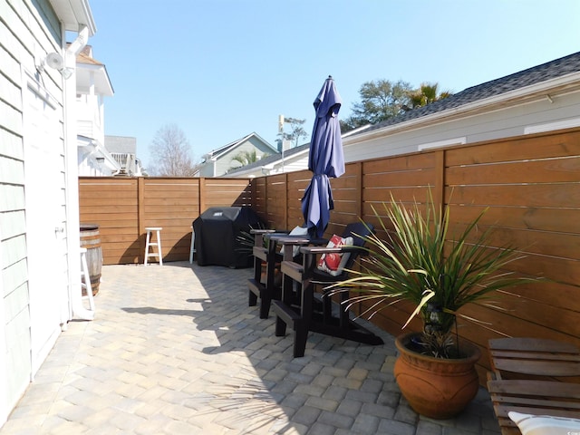 view of patio with a fenced backyard and area for grilling