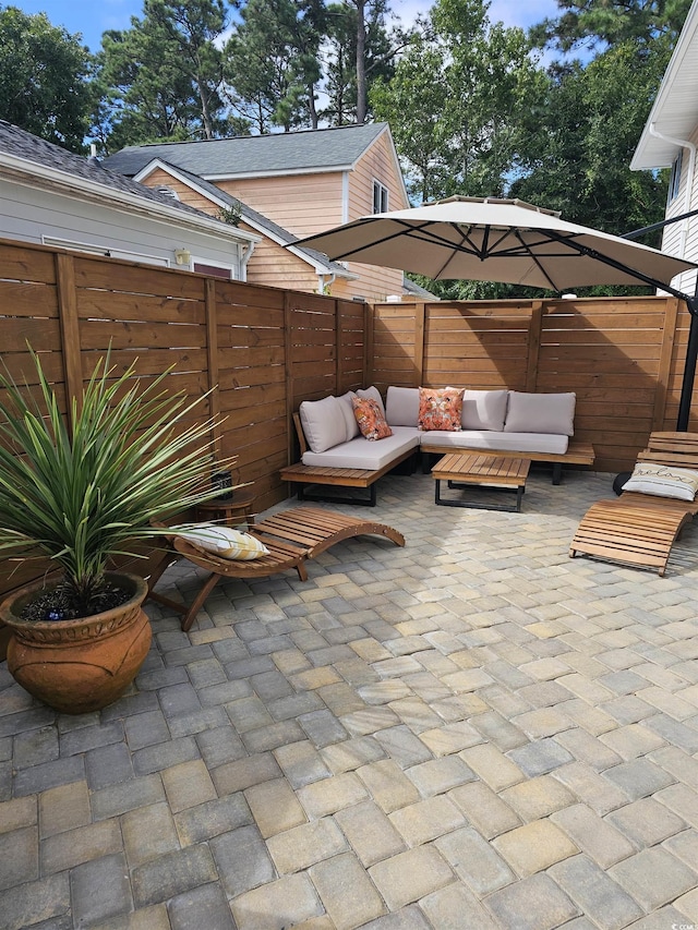 view of patio / terrace with outdoor lounge area and fence