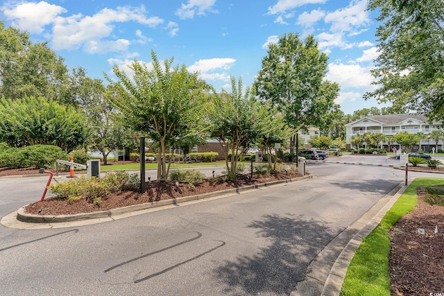 view of street featuring curbs and a gated entry