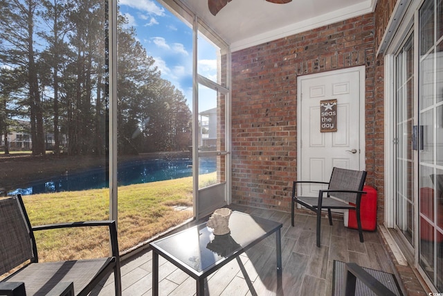 sunroom / solarium with a wealth of natural light and a ceiling fan