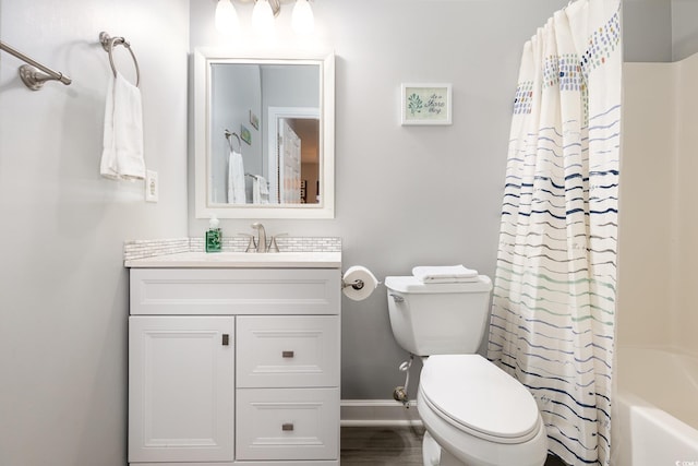 full bathroom with toilet, shower / tub combo, wood finished floors, vanity, and baseboards