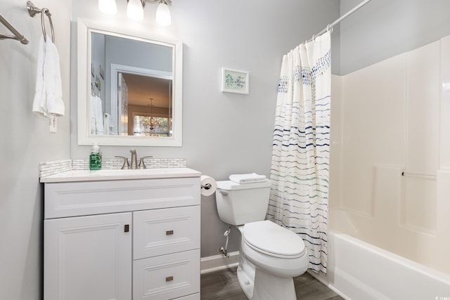 full bath featuring toilet, wood finished floors, vanity, baseboards, and shower / tub combo with curtain