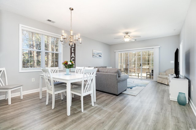 dining area featuring light wood-style flooring, visible vents, and a wealth of natural light